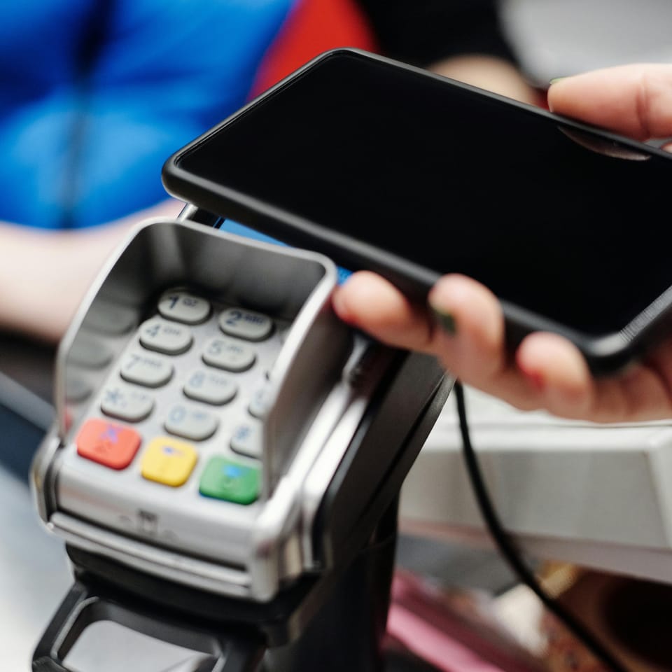 Person paying with a smartphone.